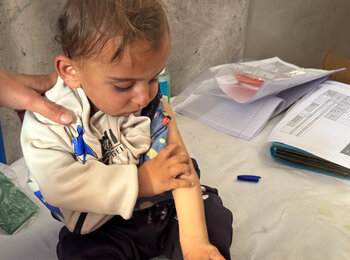 A child being screened for malnutrition in Khan Younis, 15 April 2025. Photo by OCHA/Olga Cherevko 